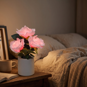 RoseLux LED Rose Night Light glowing on a nightstand